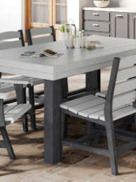 Outdoor dining area with a gray wooden table and matching benches on a tiled patio, kitchen cabinets visible in the background.